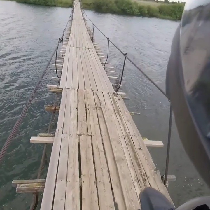 It was the rotten boards at both ends that gave me pause.

While I sat there pondering if this was a good idea or not, a small dog ran across the bridge, happily wagging his tail. 

So, of course, that reassured me that it must be perfectly safe. 😂

#bridge 
#suspensionbridge 
#mototraveler 
#mototravel 
#russia 
#drz 
#drz400
